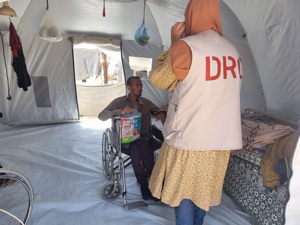 Khaled in his tent receives essential items from our staff
