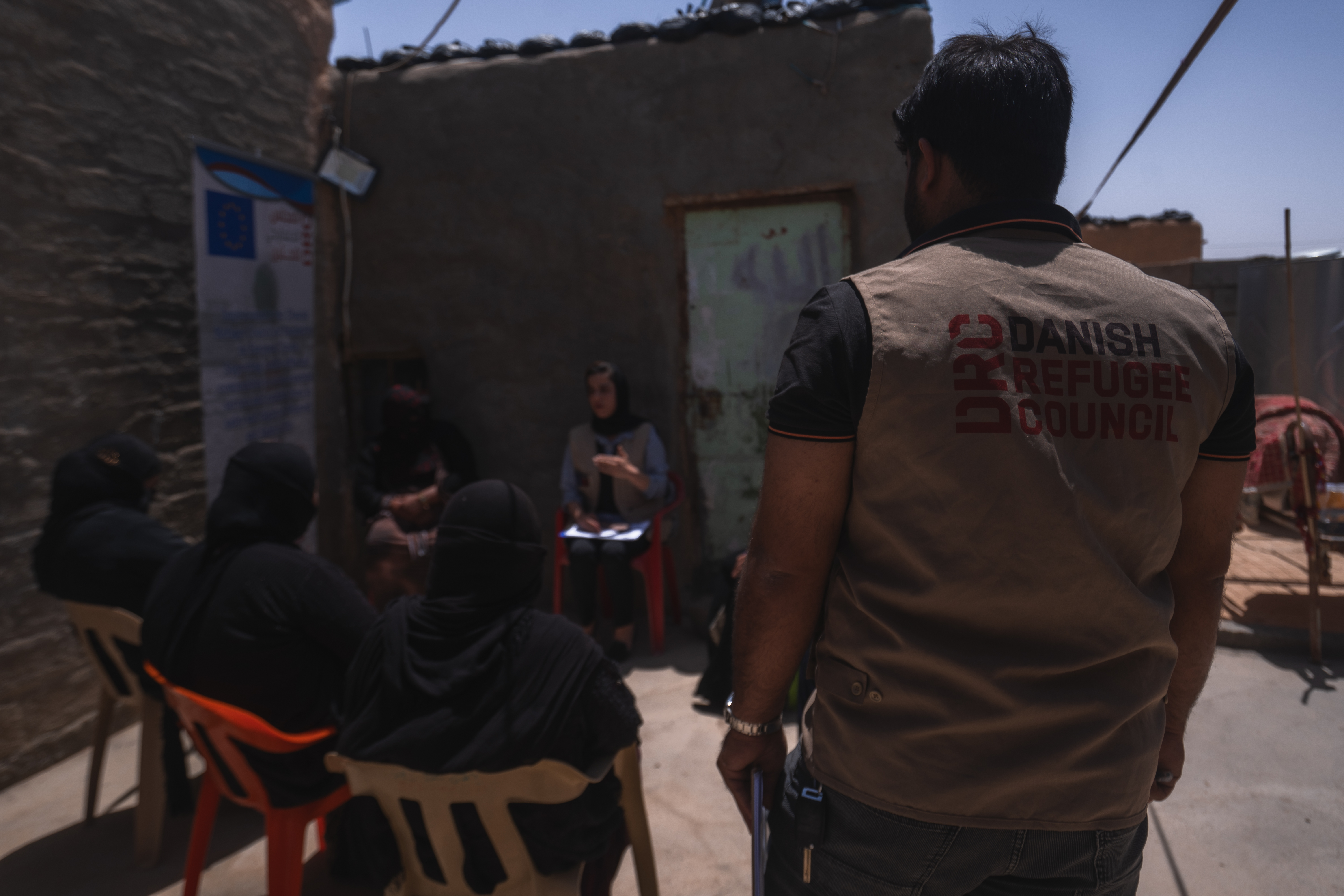 Women meet with DRC staff to receive the multi-purpose cash support