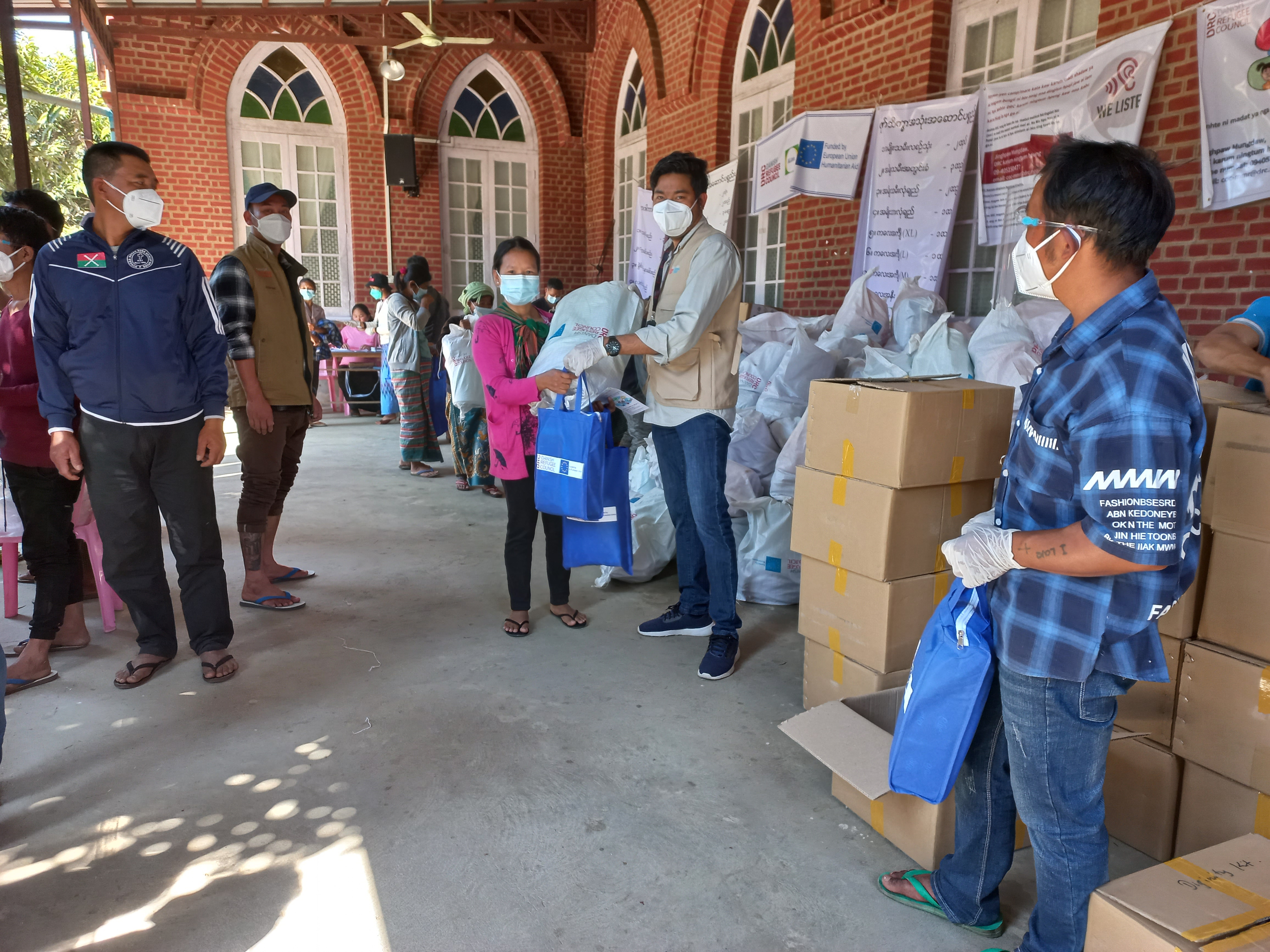 A woman recently displaced by fighting in Kachin receives hygiene, dignity and COVID-19 kit to support her and her family while displaced in a temporary and safe site.